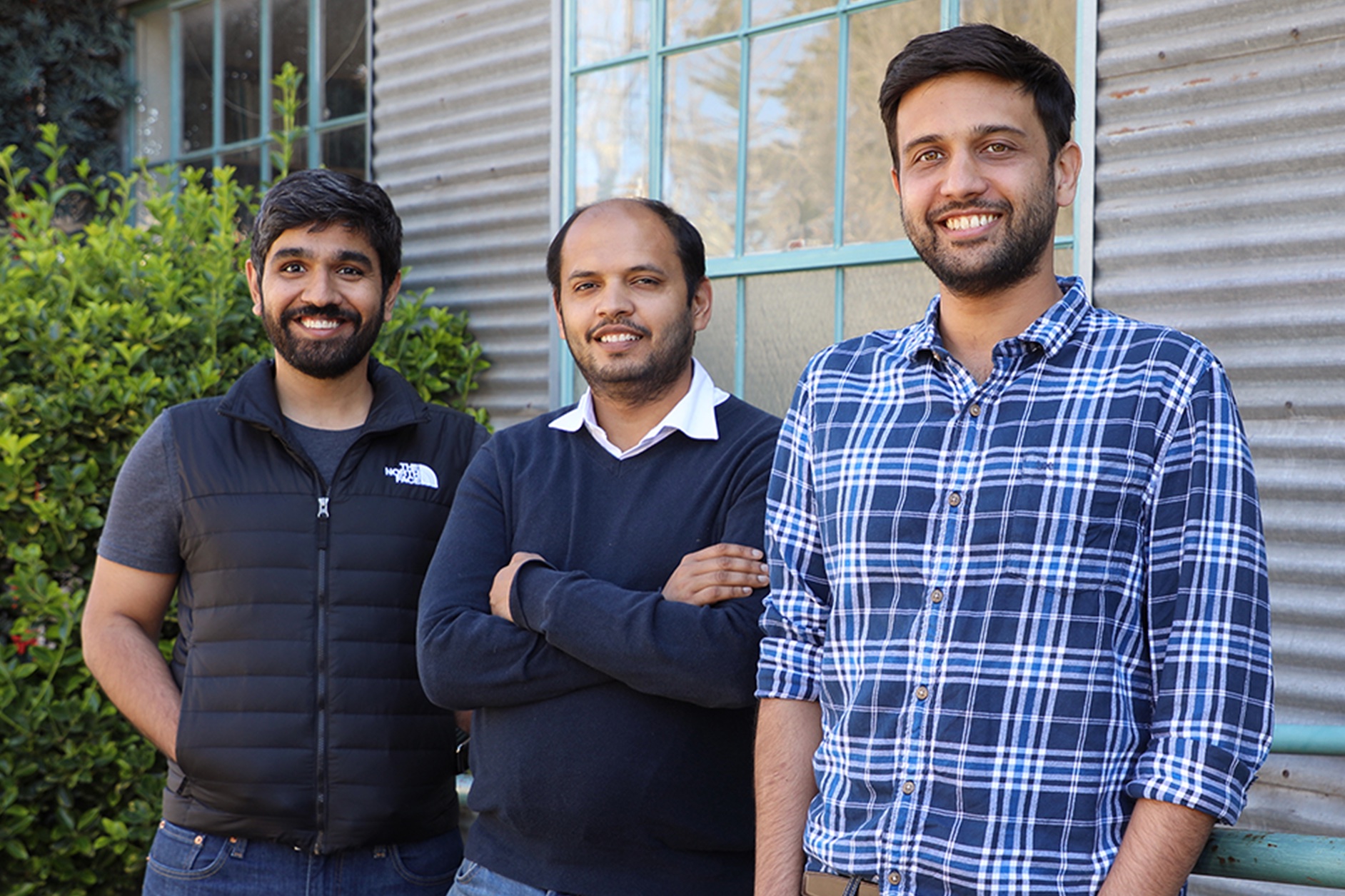 Postman's founding team standing together outdoors, smiling, in a 2023 photograph.